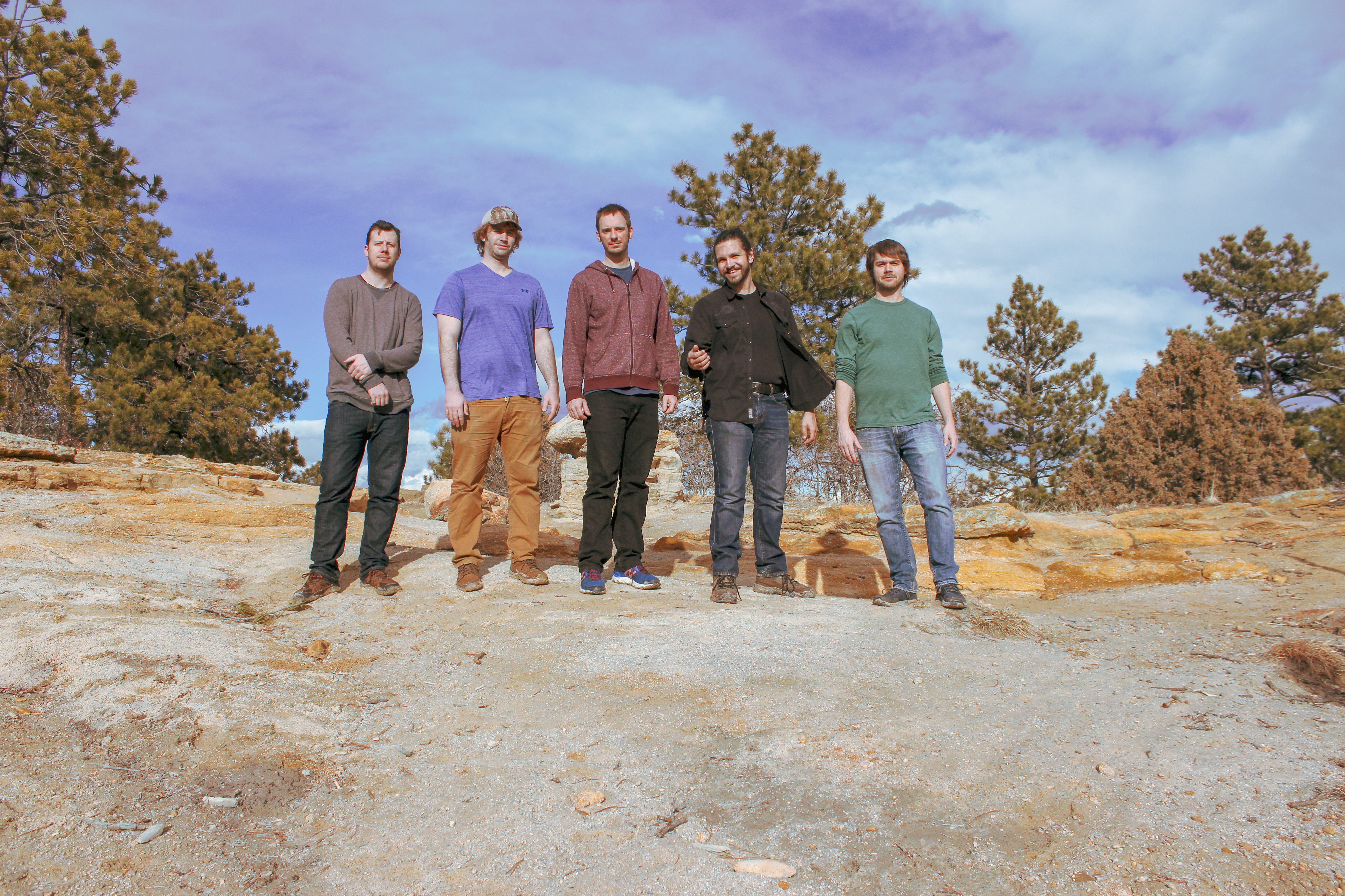 The five members of Fletcher's Grove standing together on a rock formation in Colorado